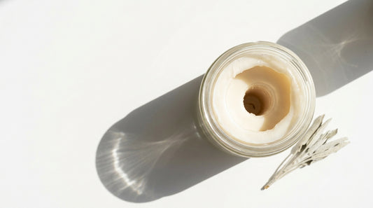 How to fix a tunneled candle: overhead view of an unlit candle with a deep narrow crater and a thick ring of unburned wax around the rim